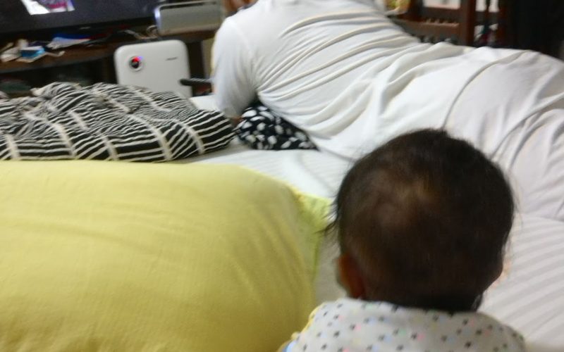Father and baby watching TV